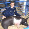 Lemoore High's Connor Deburger with his hog Chew E. Bacon at Kings Fair.
